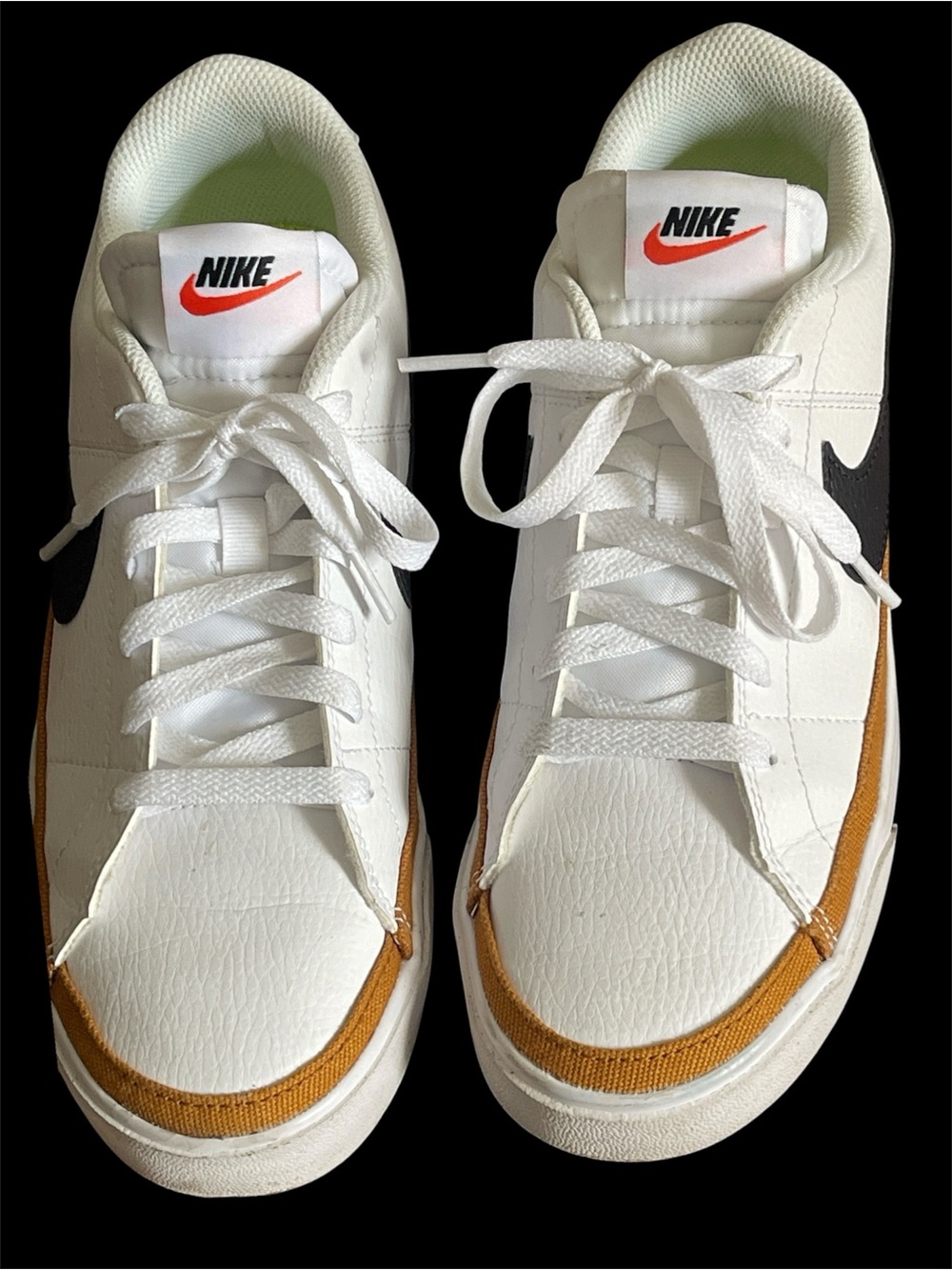 Nike White Low-Top Sneakers with Brown Trim and Black Swoosh